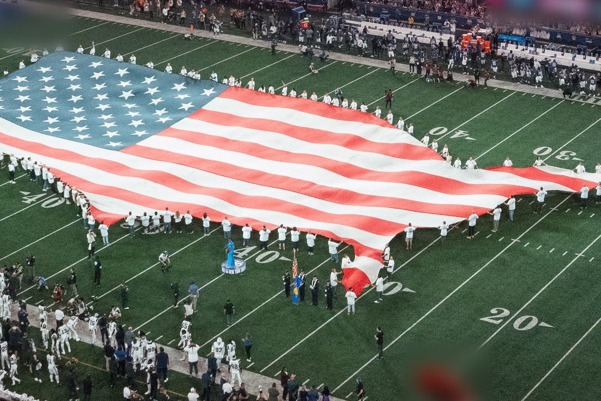 American flag across a football field