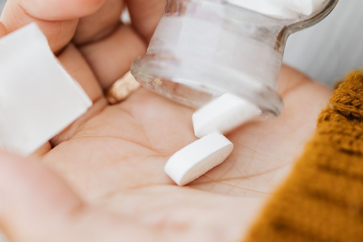 Pills pouring into a hand
